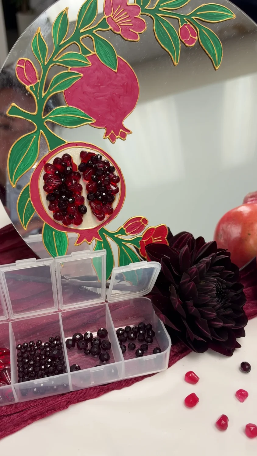 Hand-painted pomegranate mirror with raised red seeds and gold outlines