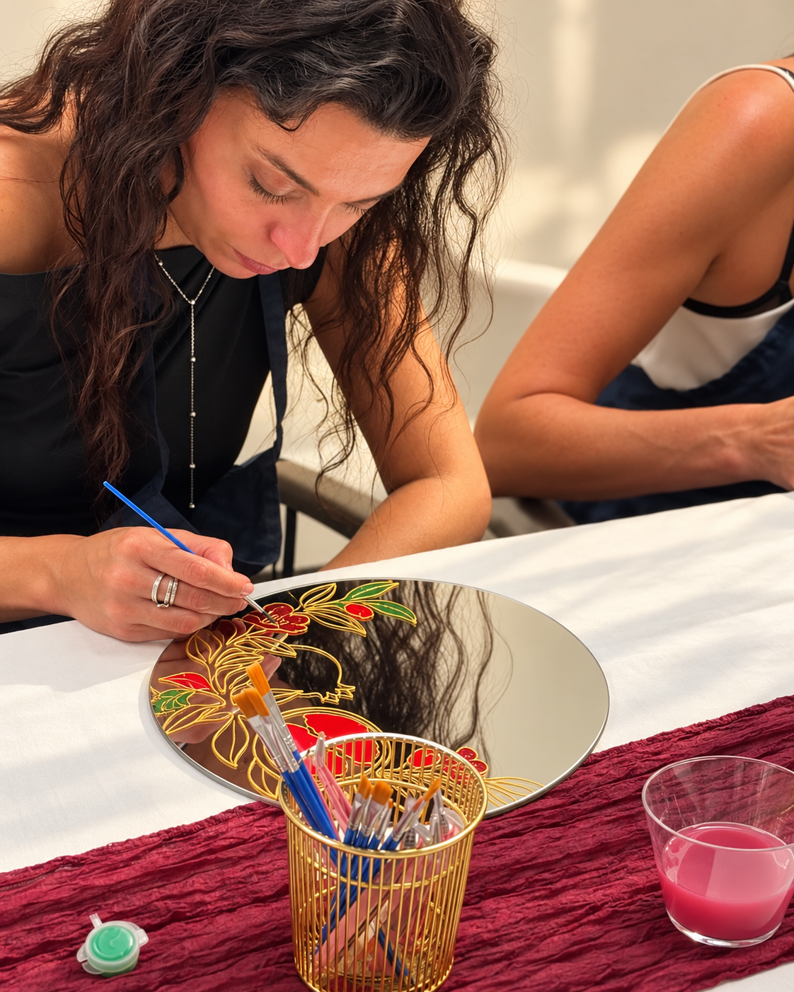 Guest painting gold-outlined flowers on her mirror