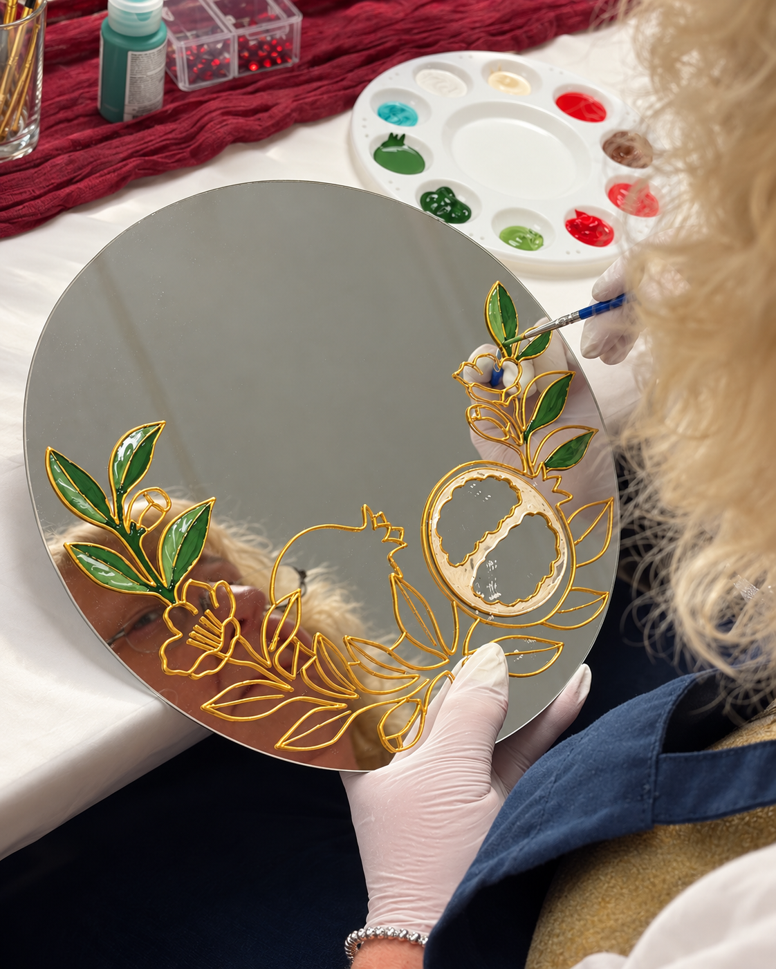 Painting green leaves inside the prepared gold outlines