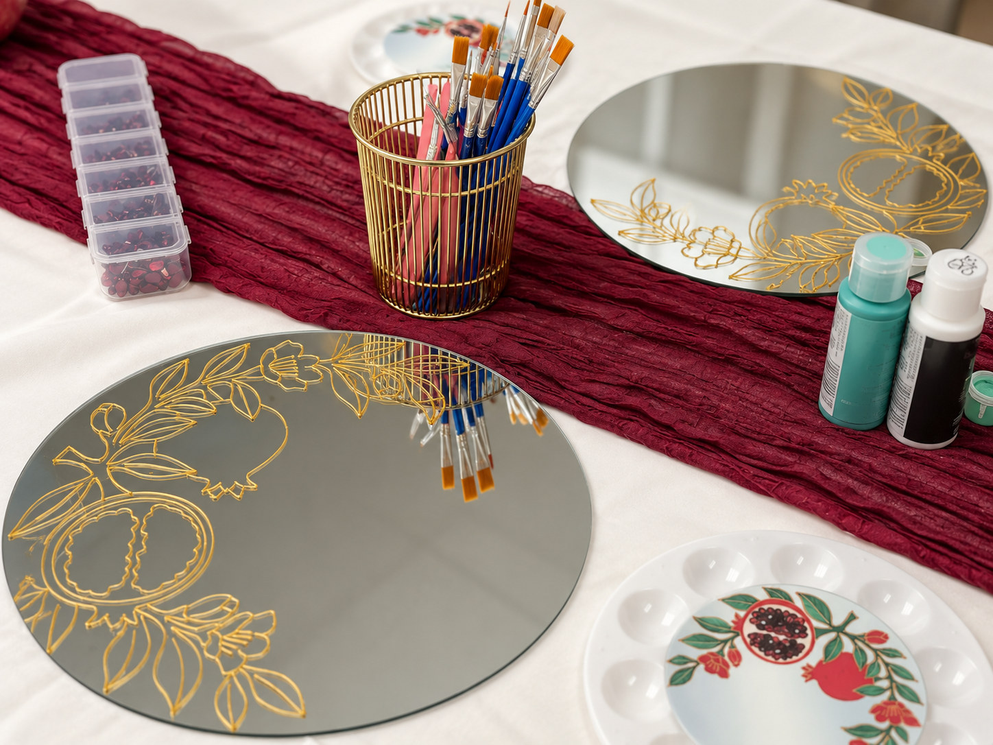 Prepared pomegranate mirrors and brushes at our workshop table, photograph retouched